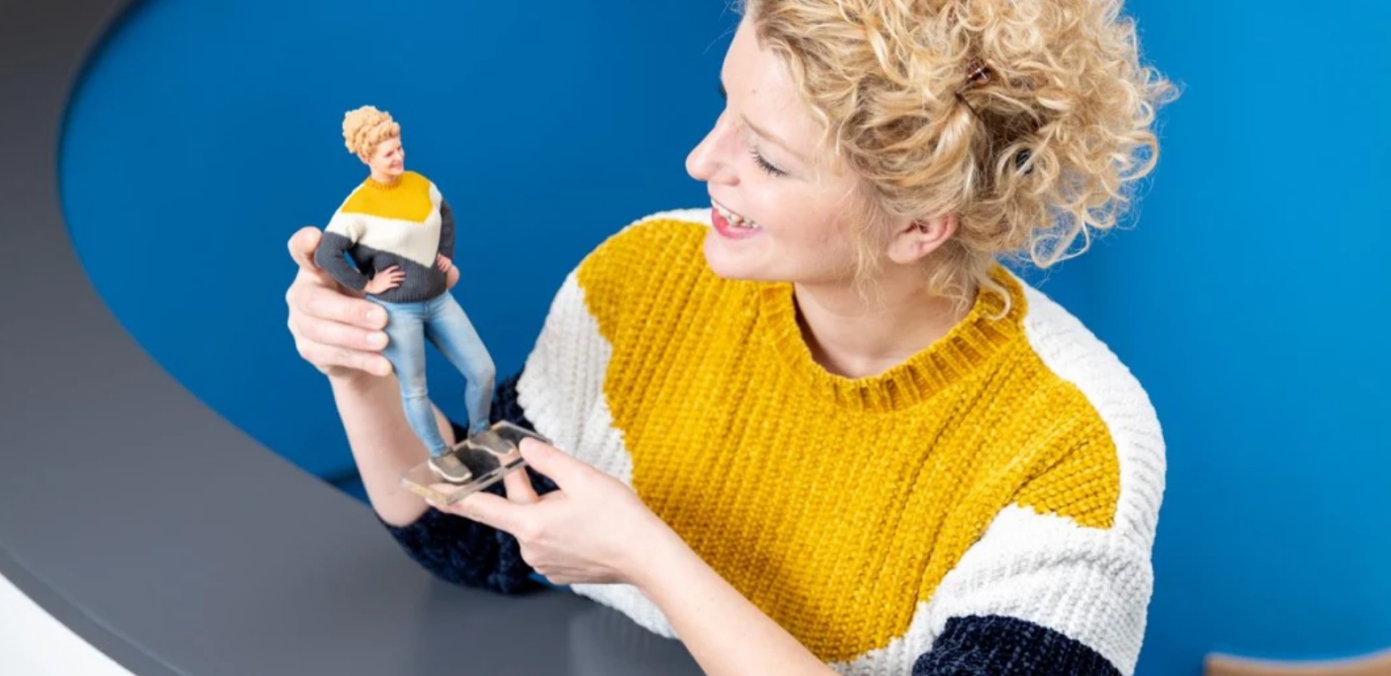 Woman holding her 3D printed figure - DIGISHOT 3D Figure showcase
